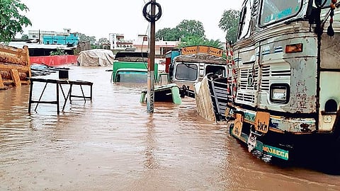 Parked trucks submerged in the town on Tuesday (photo |EPS)