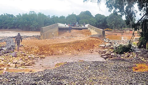 A portion of the bridge and road which were washed away during the floods at Khanapur in Belagavi district | Express