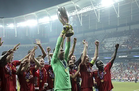 Liverpool's goalkeeper Adrian lifts up the trophy as he celebrates with players after winning the UEFA Super Cup soccer match between Liverpool and Chelsea, in Besiktas Park. (Photo | AP)