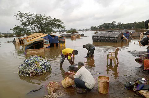 People clean their household items after flood waters receded in Kolhapur Wednesday August 14, 2019. | PTI