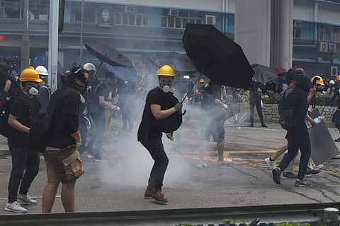 Protesters react to tear gas during a face off with riot police at Yuen Long district in Hong Kong Saturday, July 27, 2019. (Photo | AP)