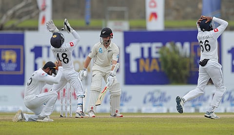 New Zealand's Kane Williamson escapes a narrow chance to get dismissed as Sri Lankan team members react during the third day of the first test cricket match between Sri Lanka and New Zealand in Galle, Sri Lanka. (Photo | AP)