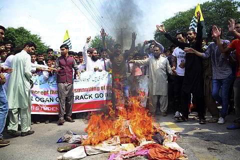 Pakistani civilians burn effigies of Indian leaders at a protest in Muzaffarabad, Pakistan, capital of Pak-occupied Kashmir (Photo | AP)