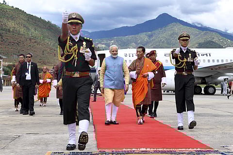 Prime Minister Narendra Modi being welcomed by his Bhutanese counterpart Lotay Tshering on his arrival at Paro International Airport. (Photo | PTI)