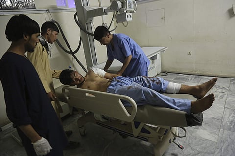 A wounded man receives treatment at a hospital after an explosion at wedding hall in Kabul, Afghanistan (Photo | AP)