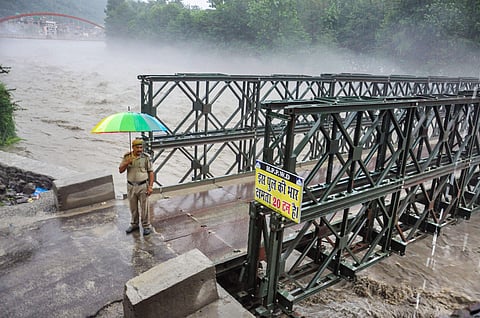 A policeman stands at the entry point of the bypass road bridge that was closed for the vehicular traffic as Beas river was flowing above the danger mark in Kullu Saturday August 17, 2019. (File Photo | PTI)