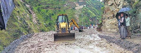 PWD’s earth-movers remove muds from Aut-Sainj road for smooth traffic, following heavy rains in Kullu district of Himachal Pradesh | ( Photo | PTI )