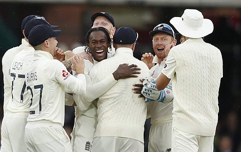 England's Jofra Archer, centre, celebrates after taking the wicket of Australia's Cameron Bancroft. (Photo | AP)