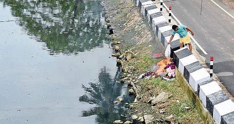 A resident burning garbage on the banks of Parvathy Puthanar at Karikkakom  B P Deepu