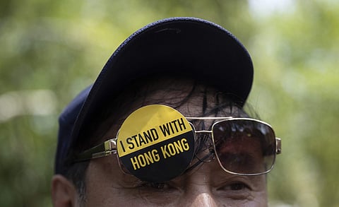 A man with a sticker that reads 'I Stand With Hong Kong' on his glasses gathered with others in Lafayette Square in front of the White House in Washington, Sunday, Aug. 18, 2019. (Photo | AP)