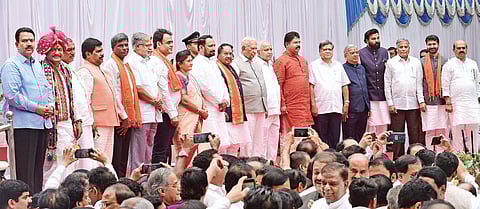 Governor Vajubhai Vala, Chief Minister B S Yediyurappa and the newly-inducted ministers pose for a photograph during the swearing-in ceremony  at Raj Bhavan, in Bengaluru on Tuesday |  Vinod Kumar T