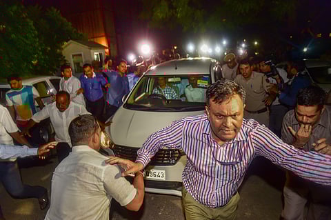 An official clears the way for the vehicle in which Central Bureau of Investigation CBI officials escorted Congress leader P Chidambaram after his arrest from his Jor Bagh residence in New Delhi Wednesday August 21 2019. | PTI