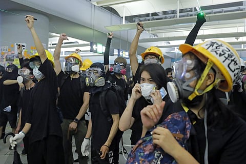 Demonstrators shine laser pointers during a protest at the Yuen Long MTR station in Hong Kong. (Photo | AP)
