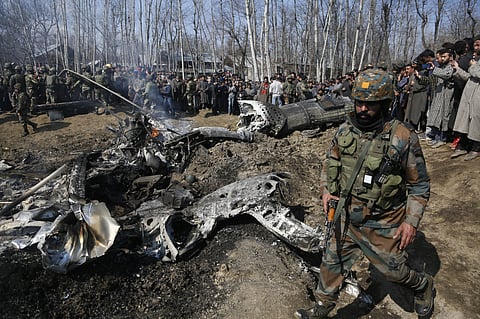 Indian army solider walks past the wreckage of an Indian aircraft after it crashed in Budgam area in the outskirts of Srinagar. (File Photo | AP)