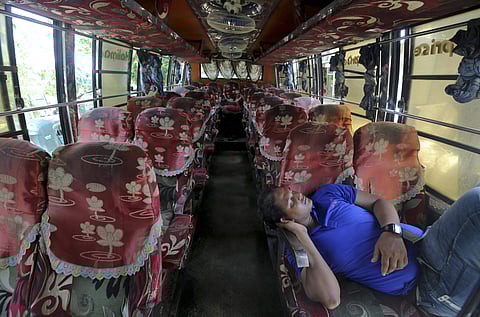 Driver of a bus that was brought to take Rohingya refugees to the Myanmar border takes rest inside the bus outside Nayapara Rohingya refugee camp in Cox's Bazar, Bangladesh, Thursday, Aug.22, 2019. Bangladesh's refugee commissioner said Thursday that no R