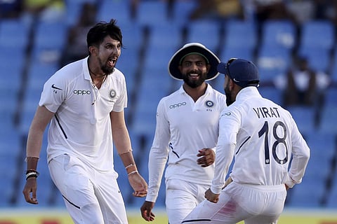 India's Ishant Sharma celebrates with captain Virat Kohli the dismissal of West Indies' Kemar Roach during day two of the first Test cricket match at the Sir Vivian Richards cricket ground in North Sound, Antigua and Barbuda. (Photo | AP)