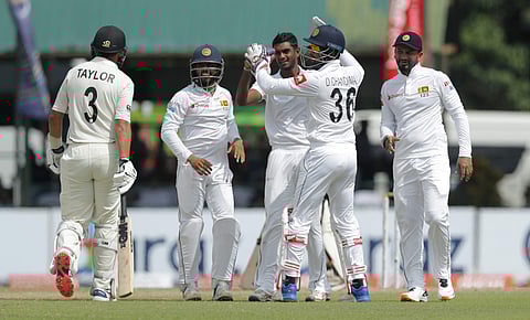 Sri Lankan team members congratulate Lasith Embuldeniya, third right, for the dismissal of New Zealand's Ross Taylor during day three of the second test cricket match between Sri Lanka and New Zealand in Colombo, Sri Lanka. (Photo | AP)