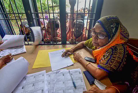 Assam: People wait in a queue to check their names on the draft of the state's National Register of Citizens. (File | PTI)