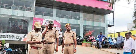 Officials at the two-wheeler showroom owned by Kodela’s son. (Photo | AP)
