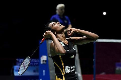 PV Sindhu rejoices after defeating Japan's Nozomi Okuhara in the finals of the BWF World Championships. (Photo | AFP)