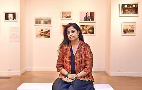 Author, researcher and artist Kota Neelima at her IHC exhibition on women farmers and farmers’ widows. (Photo | Parveen Negi, EPS)