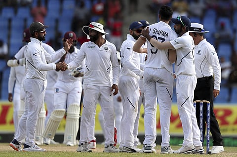 Players of India celebrate beating West Indies by 318 runs at the end of day four of the first Test cricket match at the Sir Vivian Richards cricket ground in North Sound. (Photo | AP)