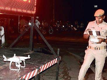 A policeman checks a drone.