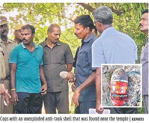 Cops with an unexploded anti-tank shell that  was found near the temple | EXPRESS