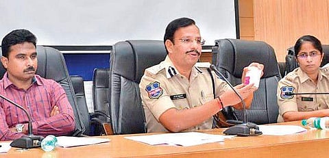 Cyberabad Police Commissioner Sajjanar displays products of  QNet during a media conference in Hyderabad on Tuesday (Photo |EPS)