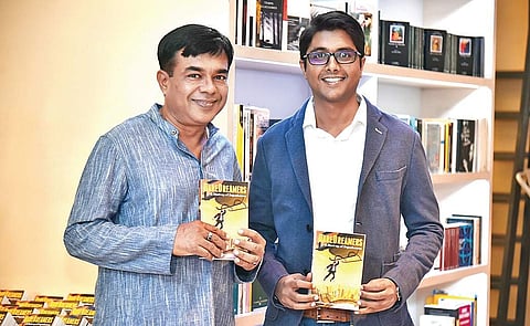 Ravi Sharma with son Kartik, holding up their second novel, Dare Dreamers