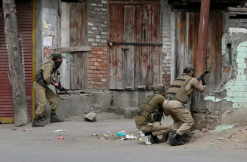 Policemen take position near the site of a gunbattle. (File Photo | AP)