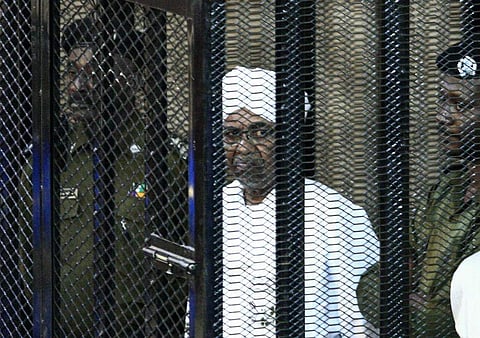 Sudan's ex-president Omar al-Bashir appears in court in the capital Khartoum to face charges of illegal acquisition and use of foreign funds (Photo | AFP)