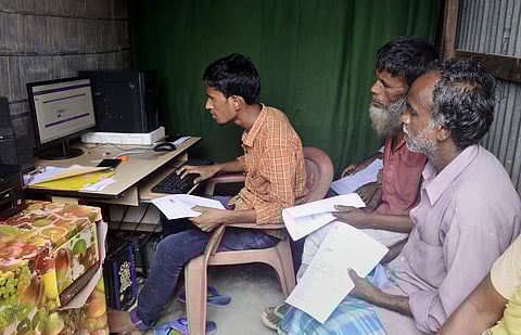 People check their names on the final NRC list. (Photo | PTI)