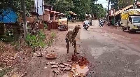 Parameshwara Gouda, has been filling potholes near Harodi village for the last four years. (Photo | EPS)