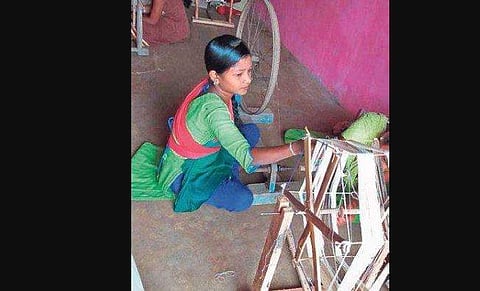 ​  A girl preparing thread at the training camp in Handakhalpada village  (PhotoI EPS)