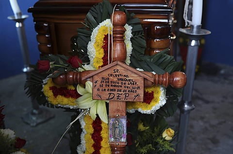 A cross bearing the name of Mexican journalist Jorge Celestino Ruiz Vazquez is displayed near the coffin containing his remains in Actopan, Mexico (Photo | AP)