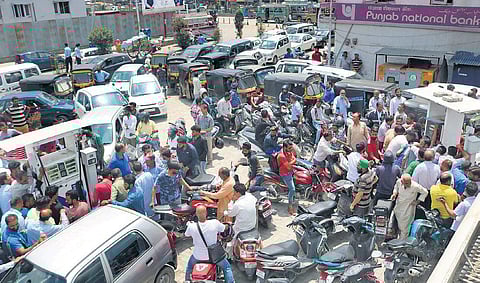 People wait to get petrol and diesel at a fuel pump in Srinagar on Saturday. There is a palpable tension among the locals after the Centre advised tourists to leave,  cut short Amarnath Yatra and boosted security deployment. (Photo | Zahoor Punjabi)