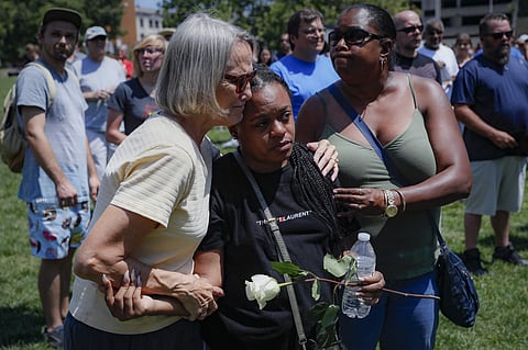 Mourners gather at a vigil following a nearby mass shooting Sunday, Aug. 4, 2019, in Dayton, Ohio. Multiple people in Ohio have been killed in the second mass shooting in the U.S. in less than 24 hours, and the suspected shooter is also deceased, police s