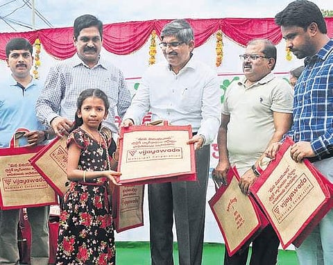 Chief Secretary LV Subramanyam, Collector A  Md Imtiaz and municipal commissioner V Prasanna Venkatesh distributing jute bags as a part of MANA VIJAYAWADA programme on Sunday | Prasant Madugula