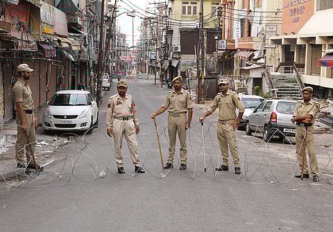 Security personnel stand guard during restrictions in Jammu Tuesday. (Photo | PTI)