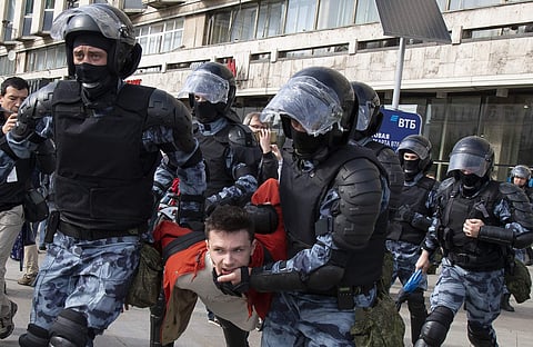 Police officers detain a protestor, during an unsanctioned rally in the center of Moscow, Russia (Photo | AP)
