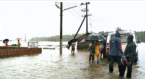 A swollen Aghanashini river flooded a road near Hegde village of Kumta on Monday (Photo | EPS)