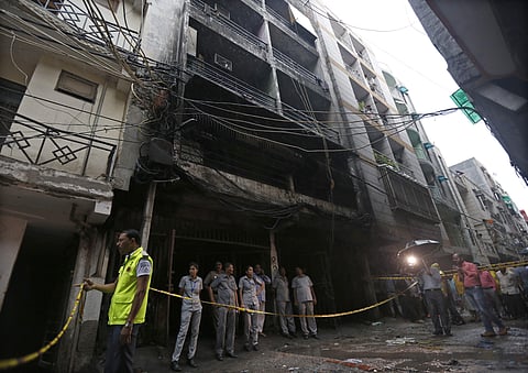 Police stand at the spot where a fire broke out in a residential building in Zakir Nagar in New Delhi on 6 August 2019. (Photo | Arun Kumar P, EPS)