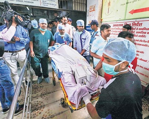 The lawyer of the Unnao rape survivor is wheeled by medical attendants outsidethe KGMC Trauma Centre in Lucknow for facilitating his airlift to New Delhi on Tuesday. | PTI