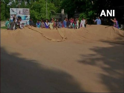 Nine visually challenged people stitched the 'world's largest jute bag' measuring 66ft-tall and 33ft-wide in just five hours.