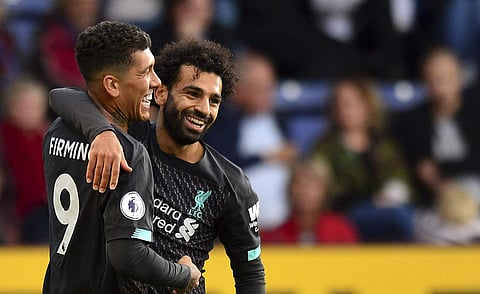 Liverpool's Roberto Firmino celebrates with Mohamed Salah after scoring against Burnley during the EPL match at Turf Moor. (Photo | AP)