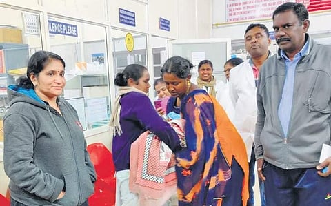 Forest officials handing over the child to her mother on Monday morning (Photo |EPS)