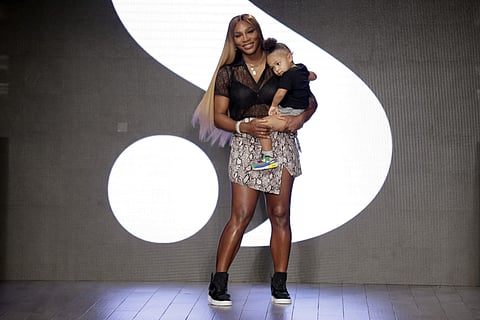 On Day 5 of New York Fashion Week, tennis legend Serena Williams presented her all-inclusive fashion line. Serena Williams made her traditional post-show bow, wearing a snakeskin wrap skirt that she designed, she was carrying little Olympia, 2, in her arm
