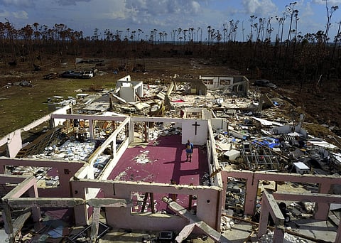 A shattered and water-filled coffin lays exposed to the elements in the aftermath of Hurricane Dorian, at the cemetery in Mclean's Town, Grand Bahama, Bahamas, Wednesday Sept. 11, 2019. (Photo | AP)