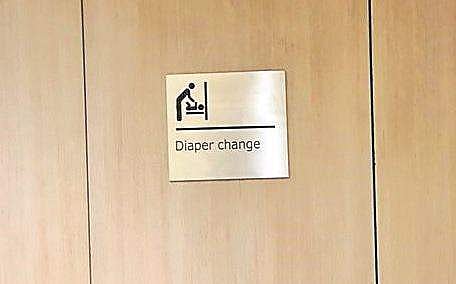 A diaper changing station in the men’s washroom at KIA